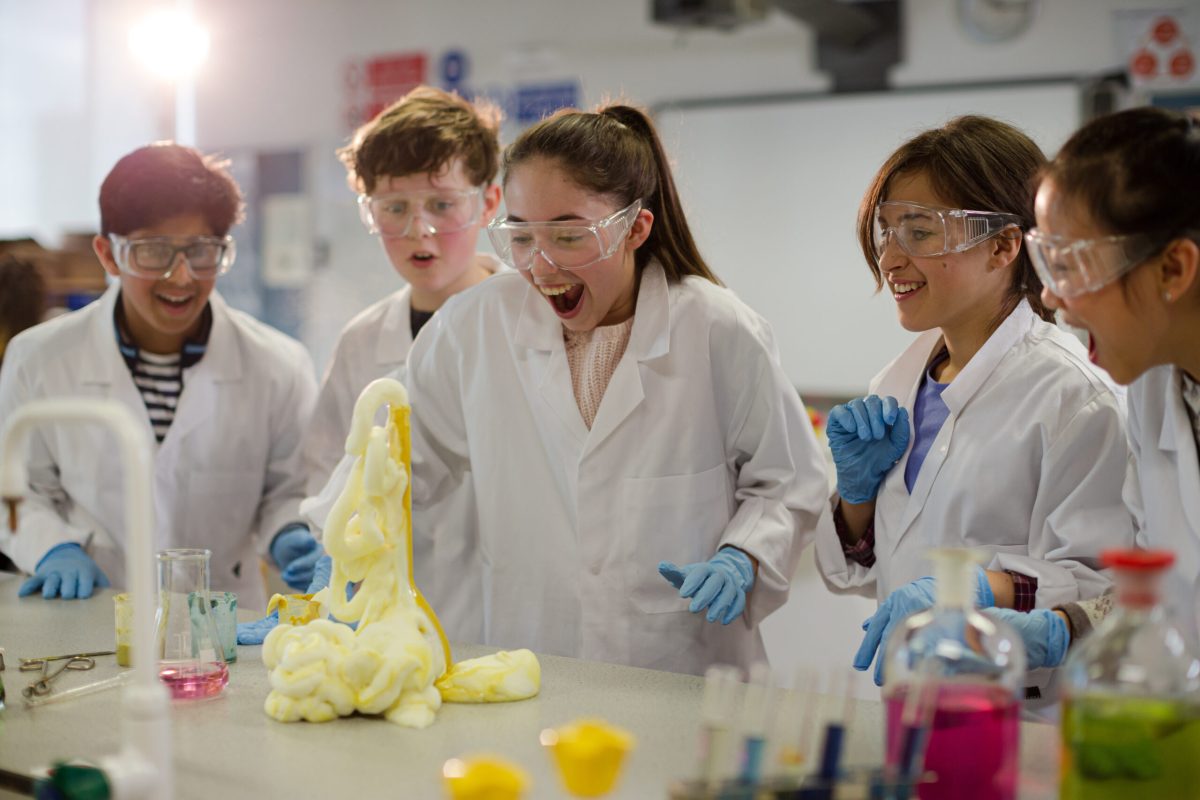 Surprised students conducting exploding foam scientific experime